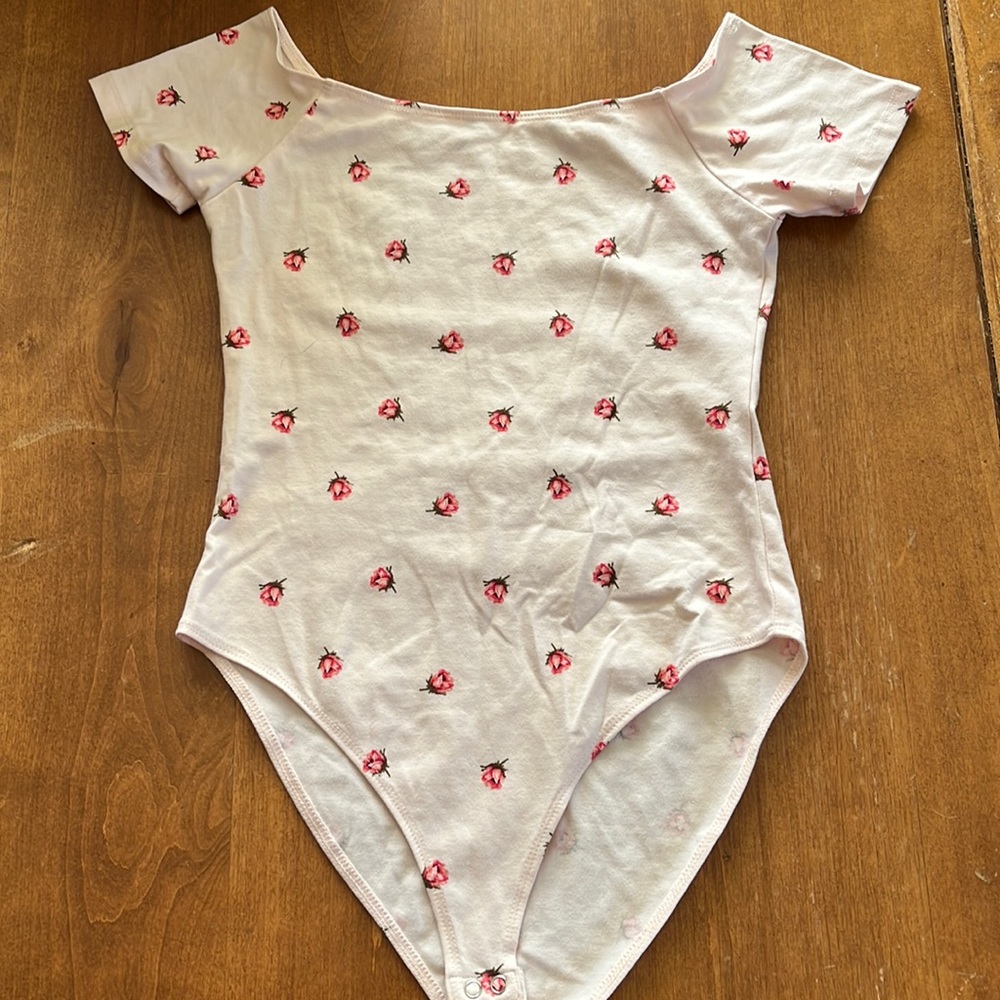 Pink bodysuit. Jr size small. Worn once. Floral details.